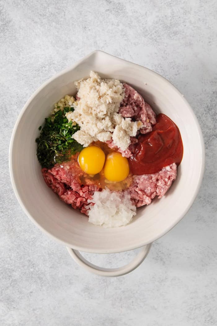 This Air Fryer Meatloaf gives you a classic comfort food meal — without the hassle of an oven. Tender and juicy, with the perfect glaze! Overhead view of ingredients for meatloaf in bowl before mixing