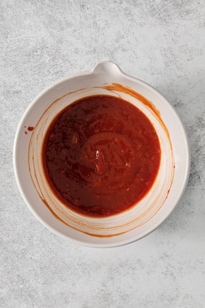 This Air Fryer Meatloaf gives you a classic comfort food meal — without the hassle of an oven. Tender and juicy, with the perfect glaze! Overhead view of meatloaf glaze in bowl