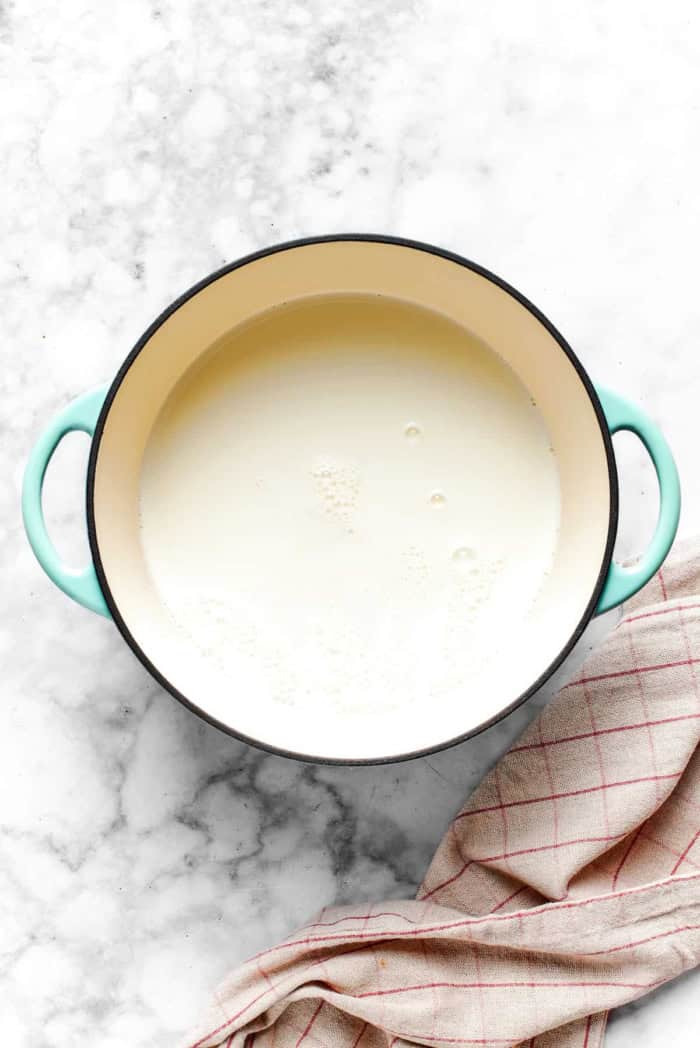 This recipe for homemade hot chocolate makes the creamiest and most decadent hot cocoa ever! It's easy to make and impossible to resist. scalding milk in a pot