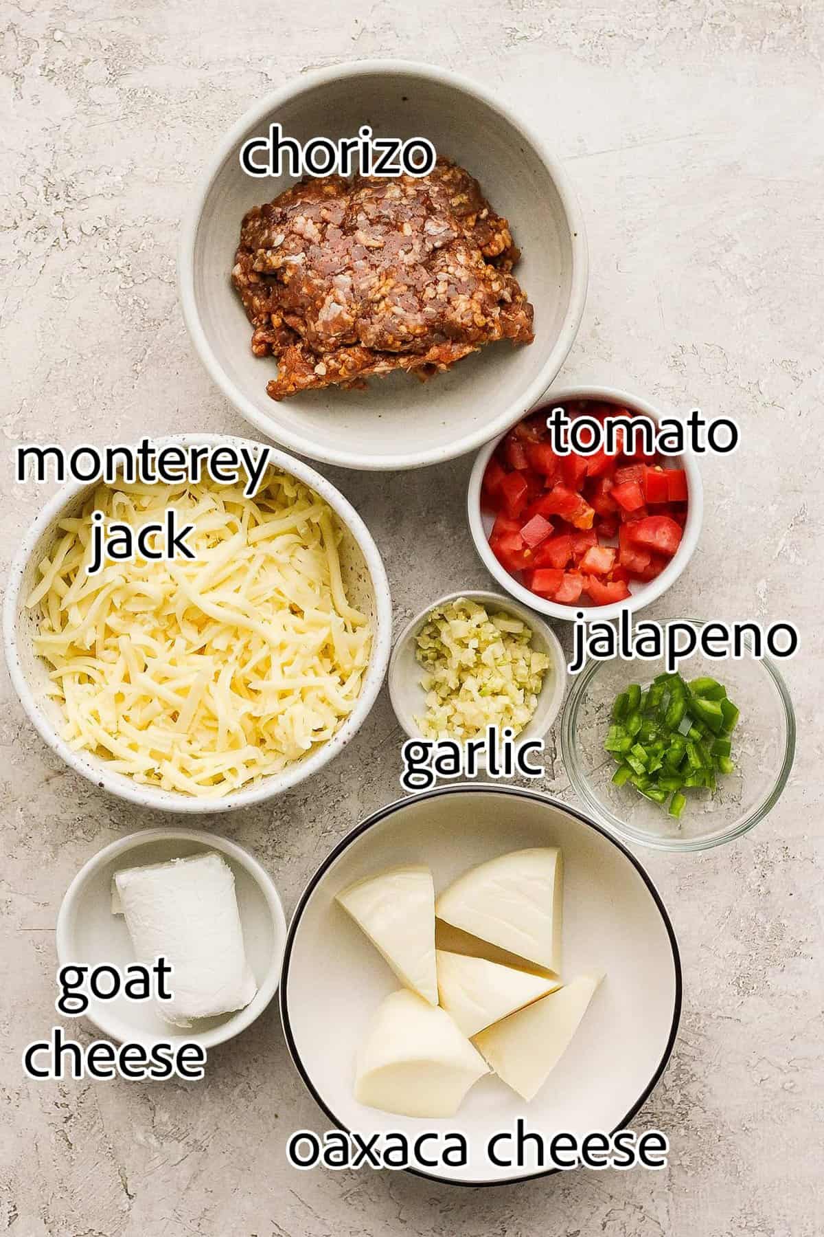 Creamy and just a little spicy, Queso Fundido is an easy, go-to dip! Melted cheese and chorizo are topped with fresh tomatoes and jalapeno. ingredients for queso fundido