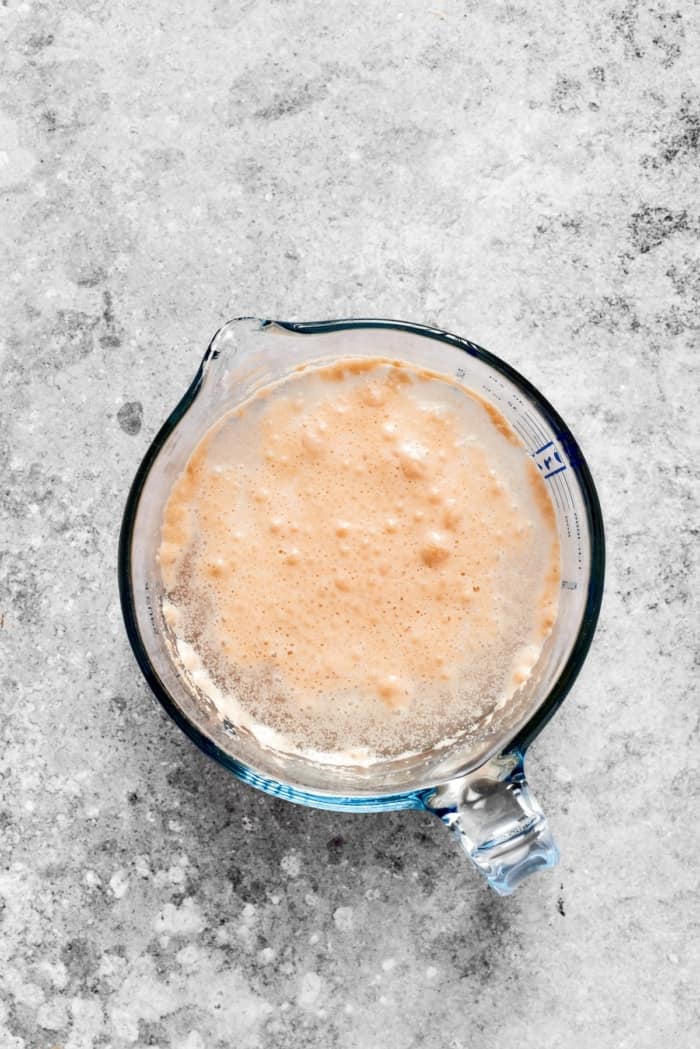 This homemade English Muffin Bread is incredibly easy, with no kneading required, and it will make your morning toast extra delicious! Yeast blooming in liquid measuring cup