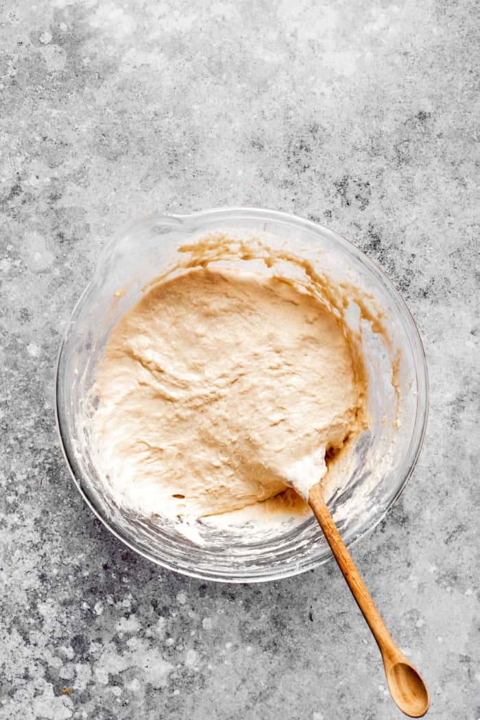 This homemade English Muffin Bread is incredibly easy, with no kneading required, and it will make your morning toast extra delicious! Overhead view of dough for English muffin bread being stirred in bowl