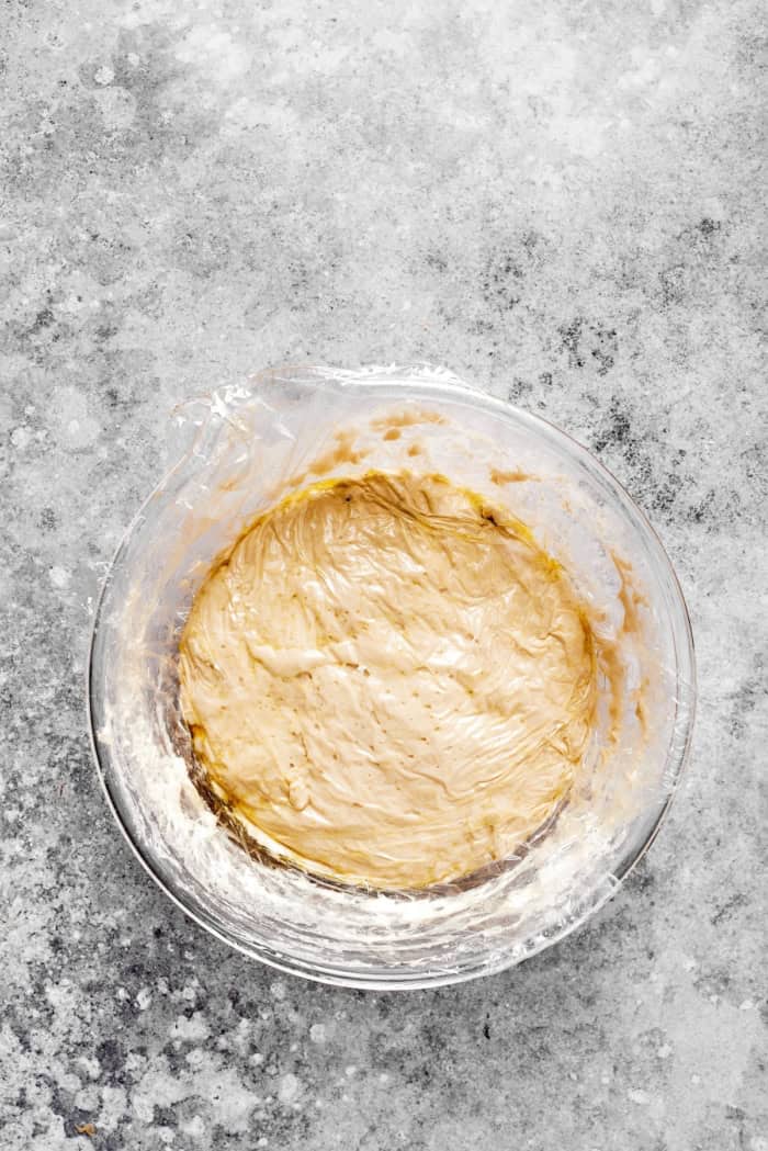 This homemade English Muffin Bread is incredibly easy, with no kneading required, and it will make your morning toast extra delicious! Overhead view of English muffin bread dough in bowl before rising