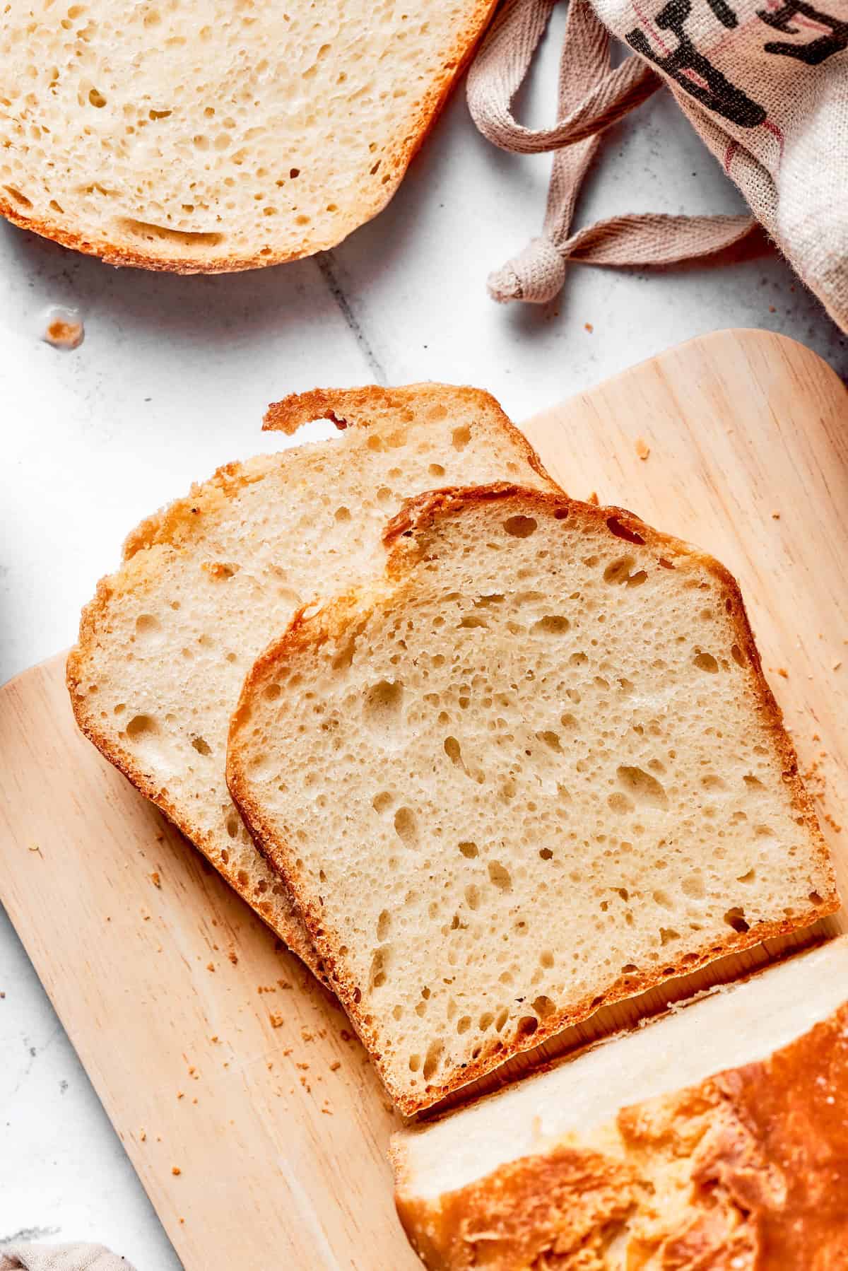 This homemade English Muffin Bread is incredibly easy, with no kneading required, and it will make your morning toast extra delicious! Overhead view of 2 slices of English muffin bread