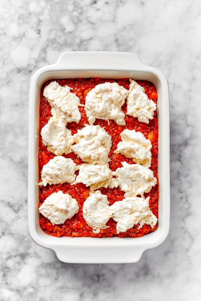 Lasagna beans pair creamy gigante beans with zippy tomato sauce, Italian sausage and ricotta, and it's all topped with even more cheese. Yum! Dollops of Cheesy Yum added to lasagna beans
