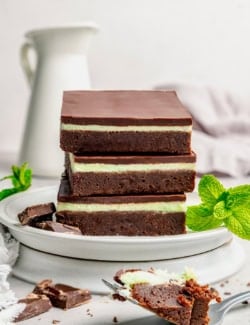 three layered chocolate mint brownies on a plate