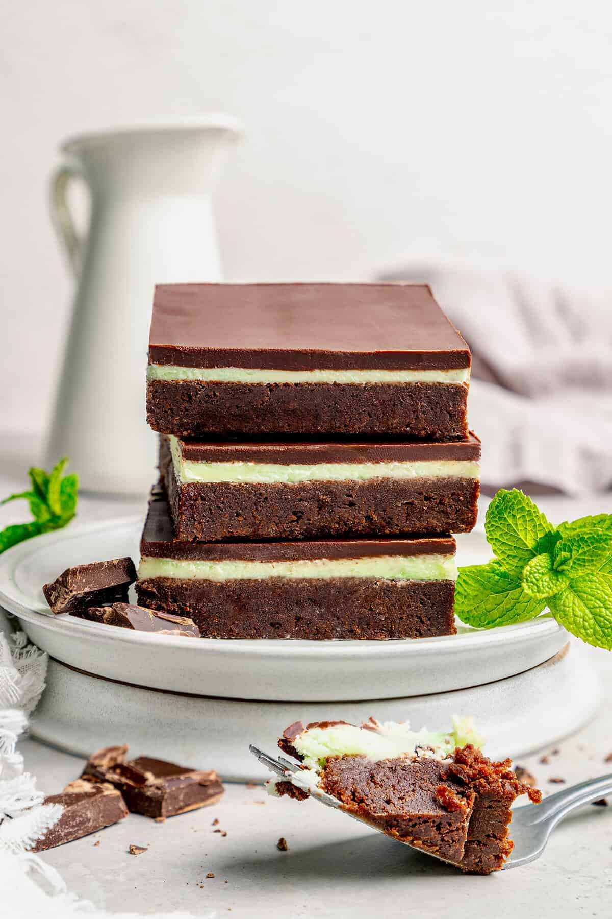 three layered chocolate mint brownies on a plate