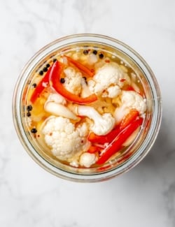 overhead photo of homemade pickled cauliflower in a jar
