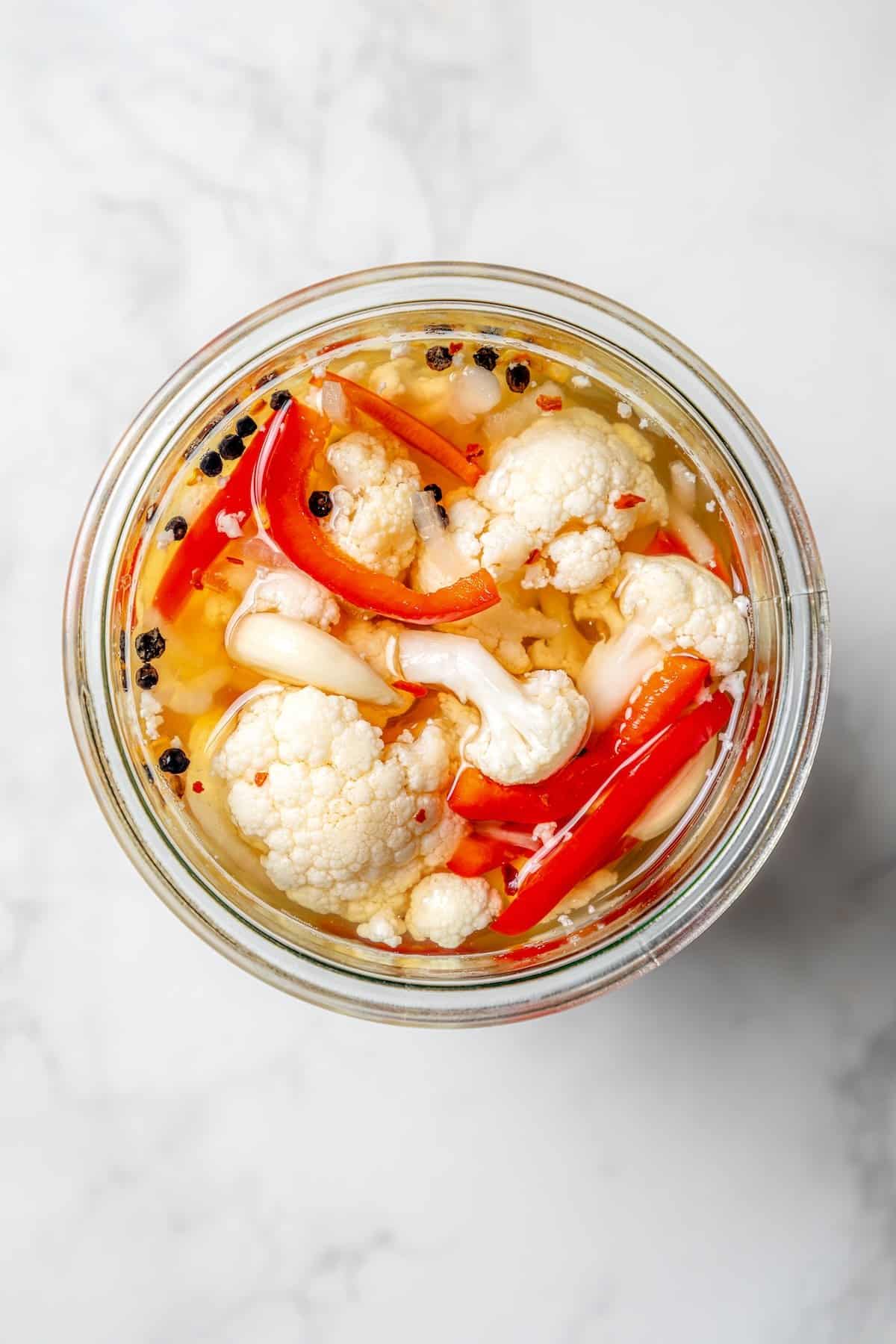 overhead photo of homemade pickled cauliflower in a jar