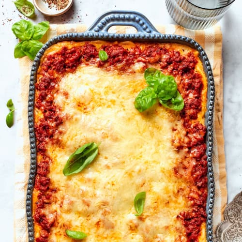 overhead photo of spaghetti casserole in a blue baking dish