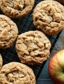 overhead photo of peanut butter cookies with apples on a cooling rack