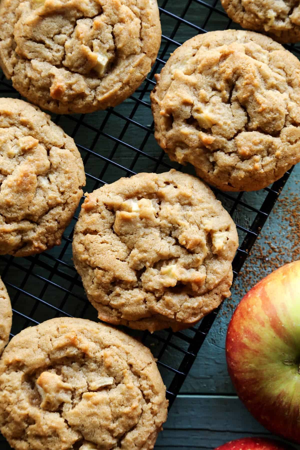 overhead photo of peanut butter cookies with apples on a cooling rack