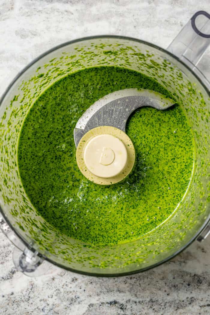 This easy Cilantro Lime Vinaigrette recipe is boldly herbaceous, brightly flavored with fresh lime, just a touch sweet and a bit garlicky. Overhead view of cilantro lime vinaigrette in food processor