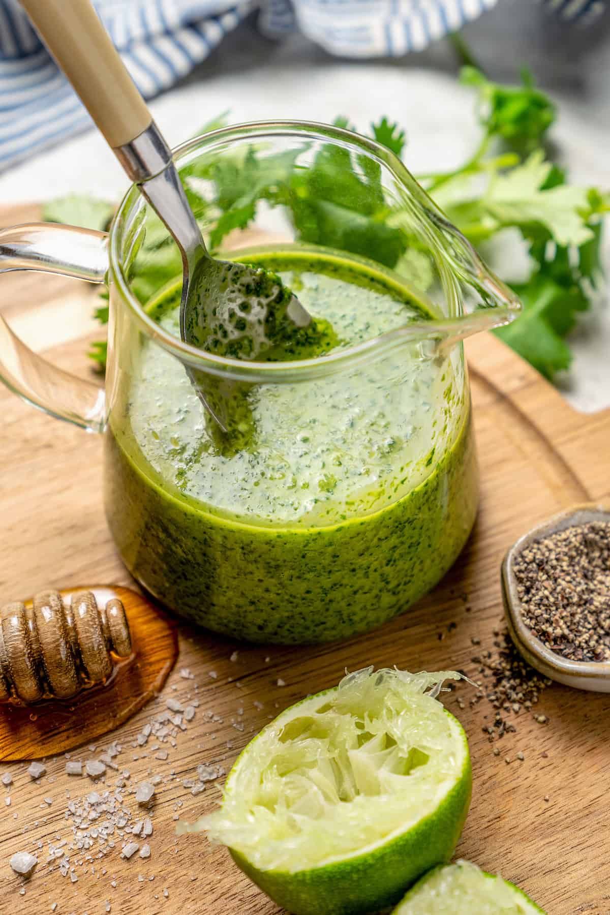This easy Cilantro Lime Vinaigrette recipe is boldly herbaceous, brightly flavored with fresh lime, just a touch sweet and a bit garlicky. Spoon in small glass pitcher of cilantro lime vinaigrette
