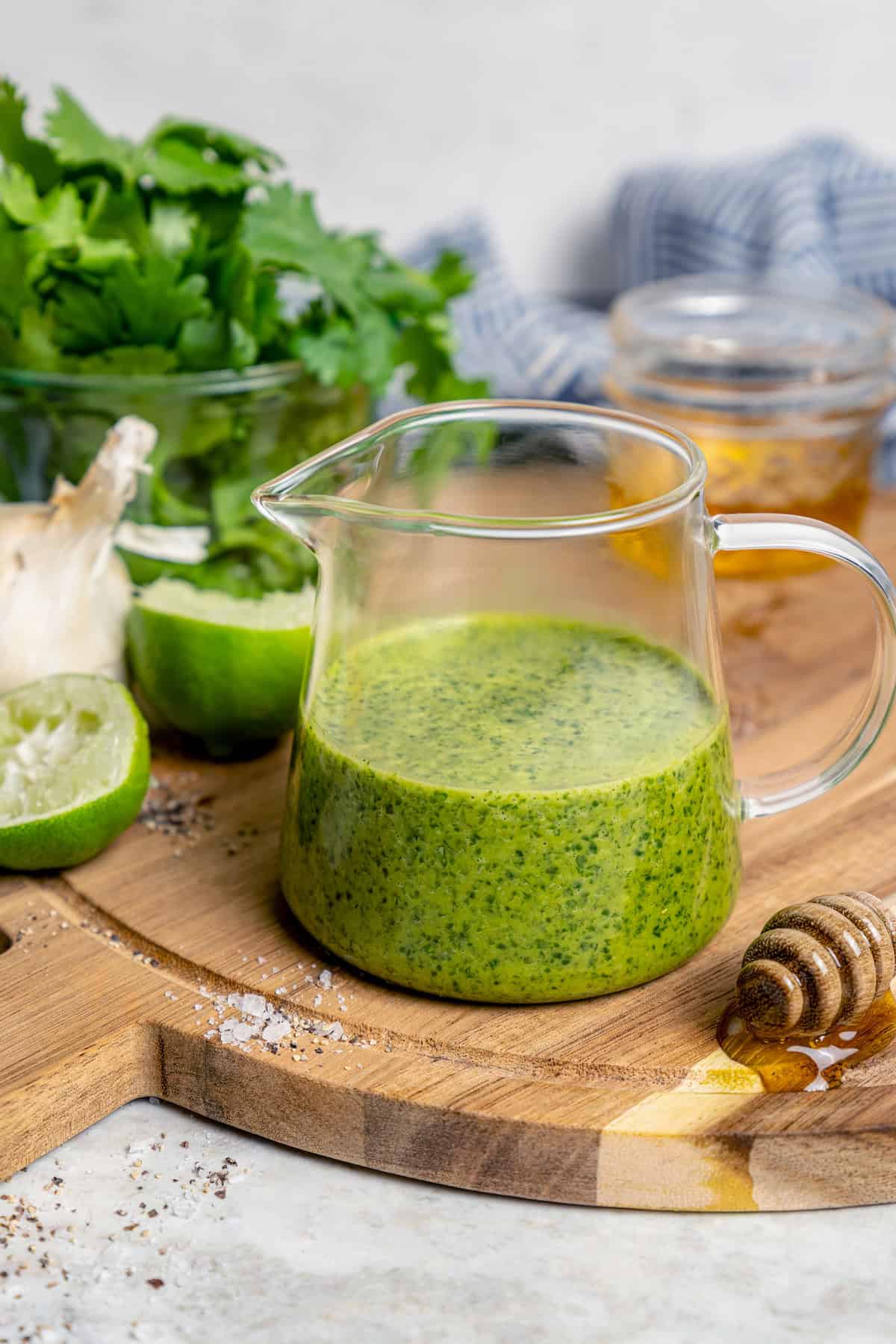 This easy Cilantro Lime Vinaigrette recipe is boldly herbaceous, brightly flavored with fresh lime, just a touch sweet and a bit garlicky. Homemade cilantro lime vinaigrette in glass pitcher