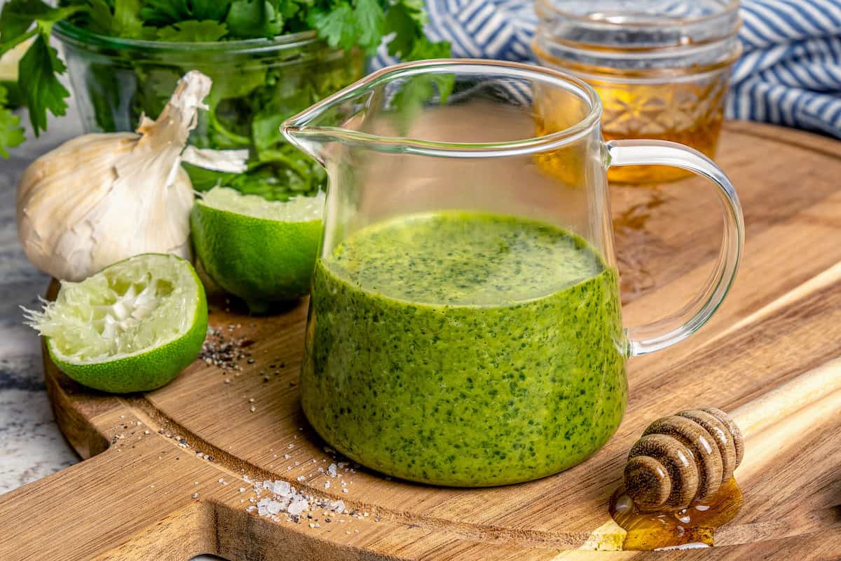 Small glass pitcher of cilantro lime vinaigrette