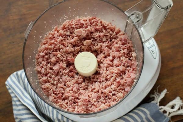 Ham Salad makes the best use of leftover ham! It's creamy and tangy, packed with crunchy vegetables, salty ham, and sweet pickle relish. chopped ham in a food processor bowl