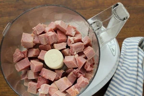 Ham Salad makes the best use of leftover ham! It's creamy and tangy, packed with crunchy vegetables, salty ham, and sweet pickle relish. cubes of ham in a food processor bowl