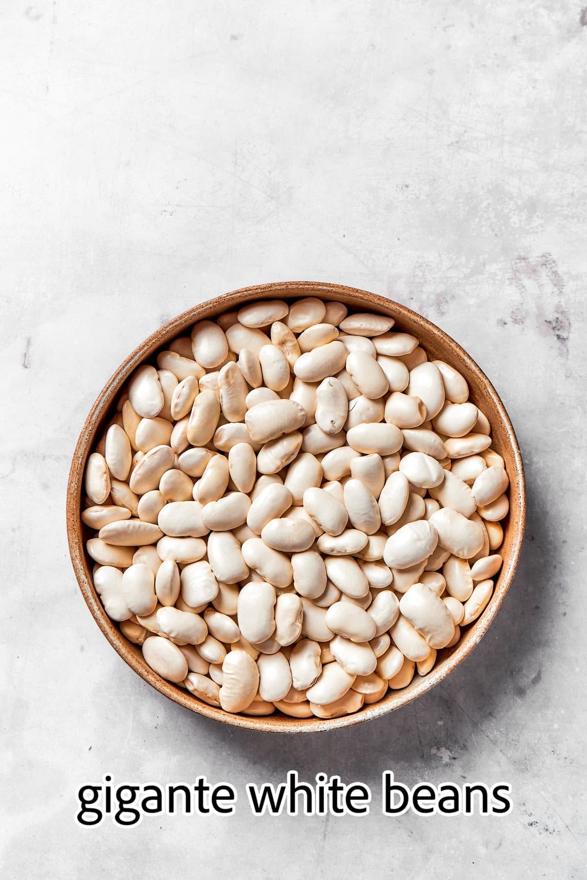 Lasagna beans pair creamy gigante beans with zippy tomato sauce, Italian sausage and ricotta, and it's all topped with even more cheese. Yum! a bowl of uncooked gigante white beans