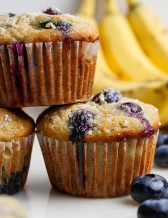 Closeup of 3 stacked banana blueberry muffins