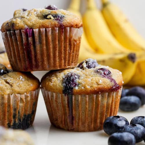 Closeup of 3 stacked banana blueberry muffins