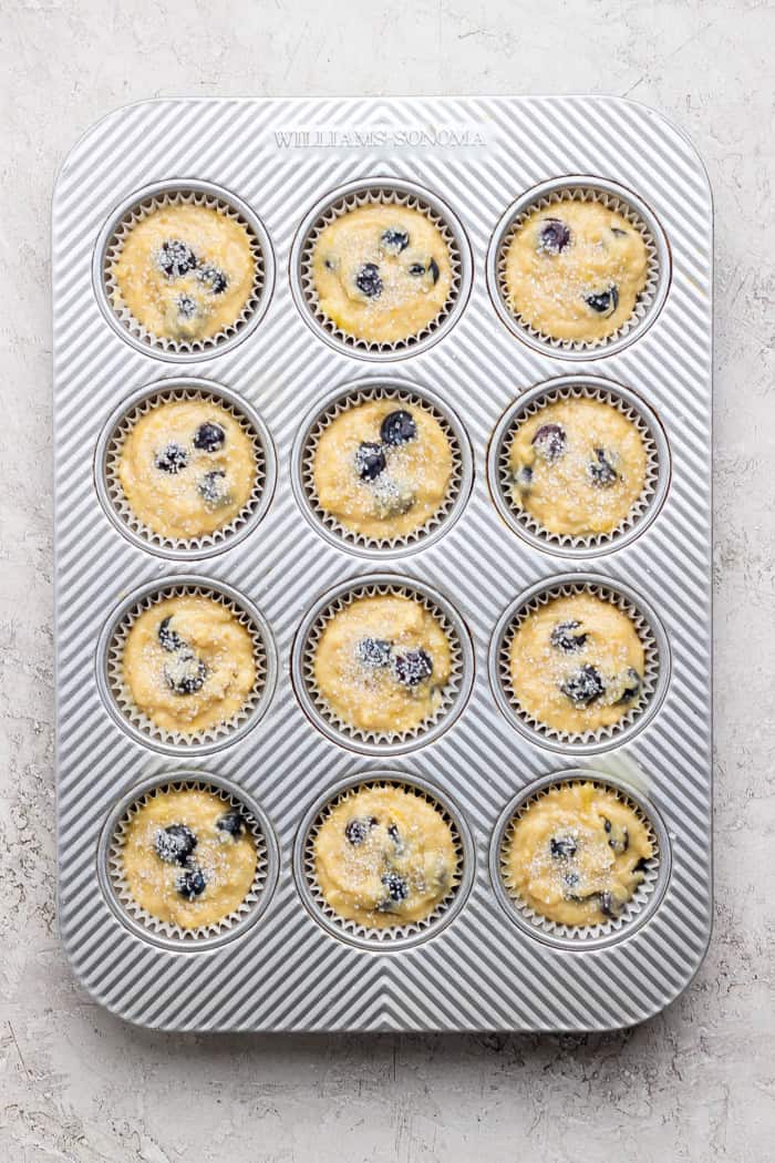 Banana Blueberry Muffins combine two classic recipes into one moist, lofty, perfectly sweet muffin package. They're such a treat! Overhead view of banana blueberry muffin batter in pan