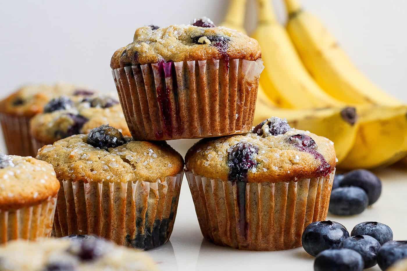 Banana Blueberry Muffins combine two classic recipes into one moist, lofty, perfectly sweet muffin package. They're such a treat! Stack of 3 banana blueberry muffins