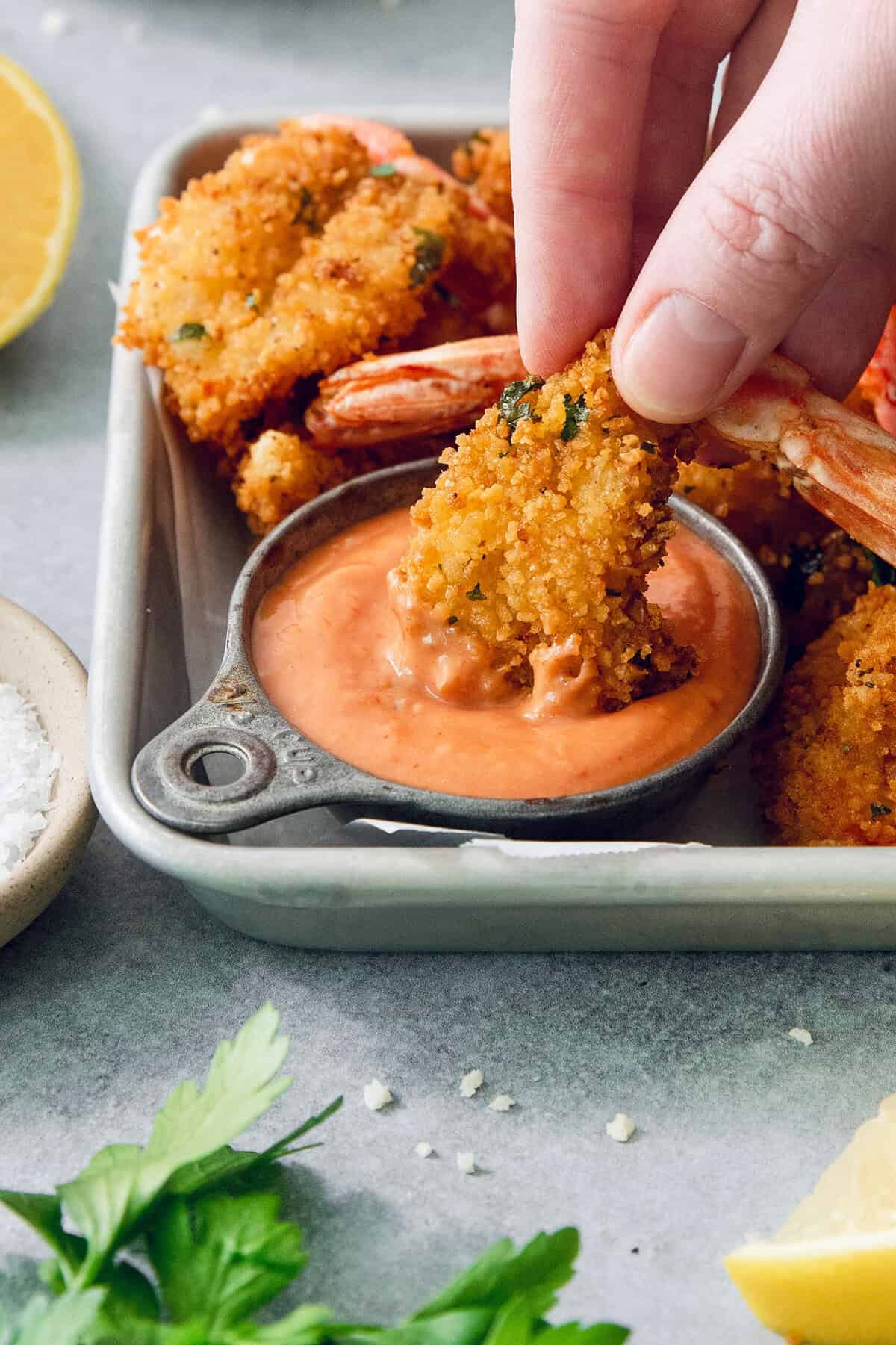 These butterfly shrimp are tender and juicy on the inside, crisp and crunchy on the outside, and paired with a spicy creamy cocktail sauce! Dipping butterfly shrimp into cup of creamy cocktail sauce