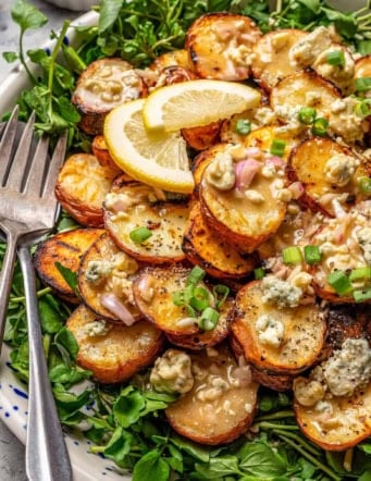 grilled red potato salad on a platter with watercress