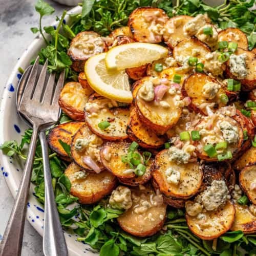 grilled red potato salad on a platter with watercress