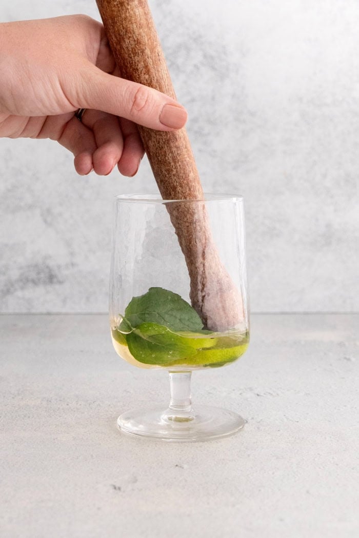 This fizzy Hugo spritz is easy to make, with a crisp, refreshing flavor and a little bit of floral complexity thanks to elderflower liqueur. Muddling lime and mint with St-Germain in glass