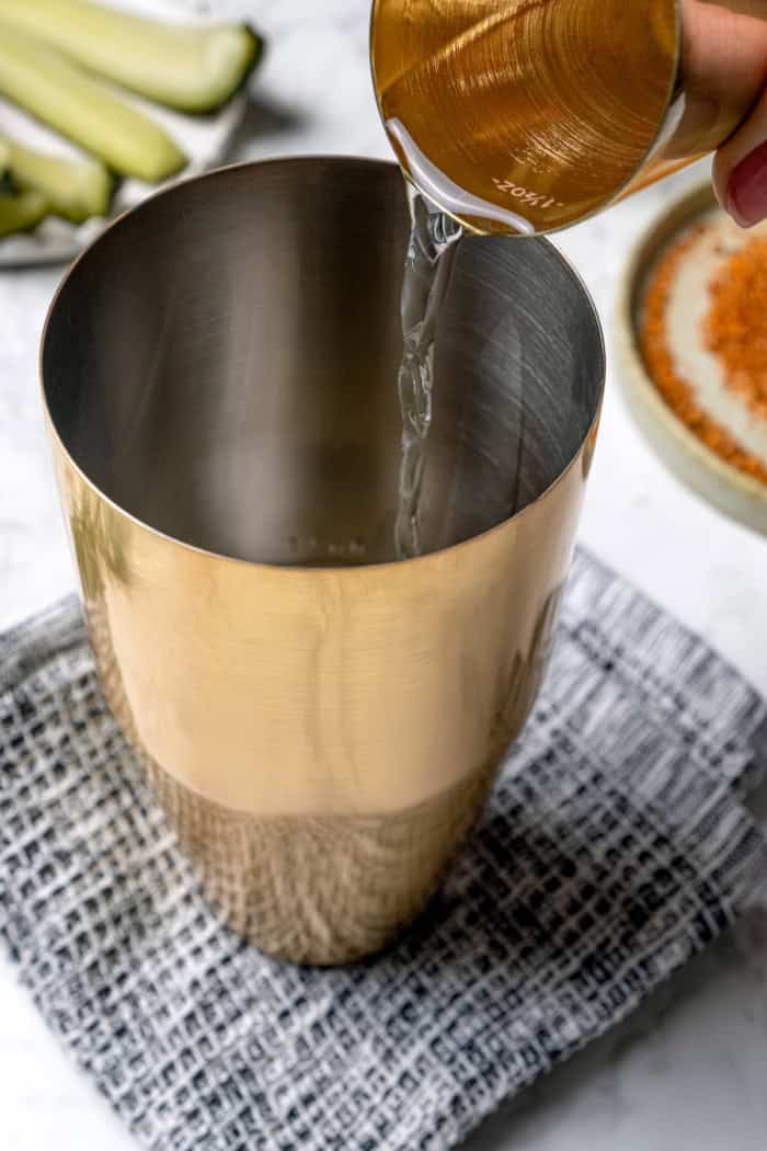 This Pickle Margarita recipe is bright and citrusy just like the classic, but it has a little extra pop of flavor to make it truly special! Pouring tequila into cocktail shaker