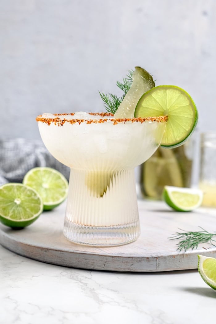 This Pickle Margarita recipe is bright and citrusy just like the classic, but it has a little extra pop of flavor to make it truly special! Pickle margarita garnished with pickle spear, dill, and lime wheel