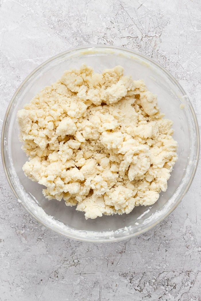 Overhead view of cake batter topping in glass mixing bowl