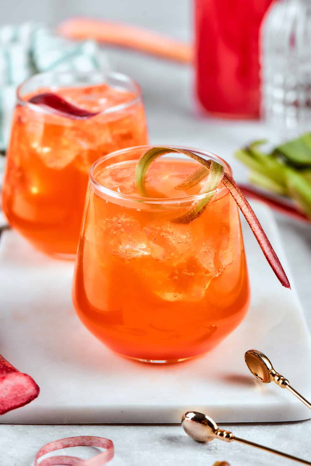 Midwest meets Italy in this summery Rhubarb Aperol Spritz! It’s a light, sparkling and refreshing cocktail perfect for using up fresh rhubarb. Two rhubarb aperol spritz cocktails