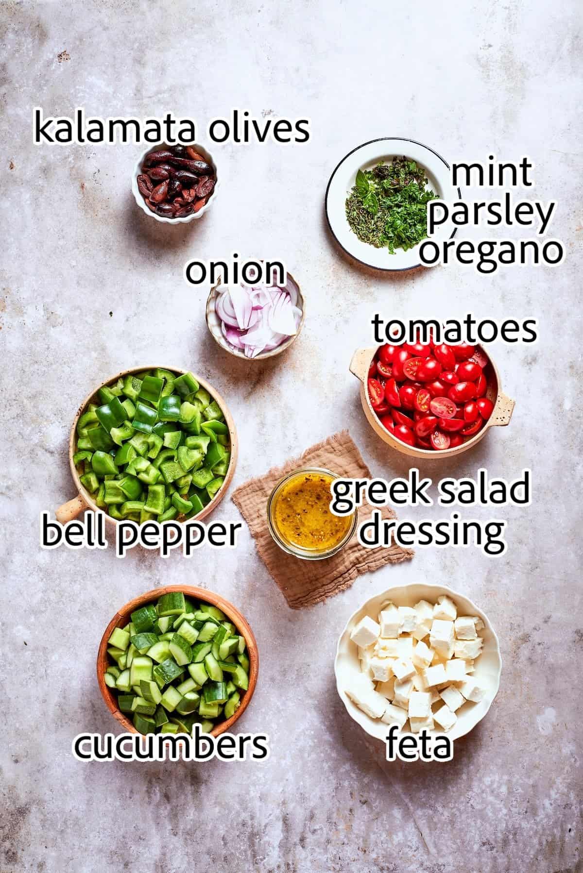 This Greek Chopped Salad is loaded with fresh cucumbers, tomatoes, bell peppers, and herbs and drizzled with a bright, flavorful dressing. ingredients needed for chopped greek salad