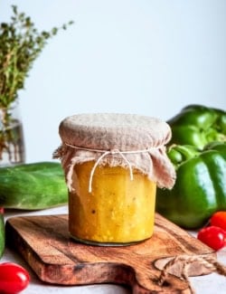 Jar of Greek salad dressing with burlap tied around lid