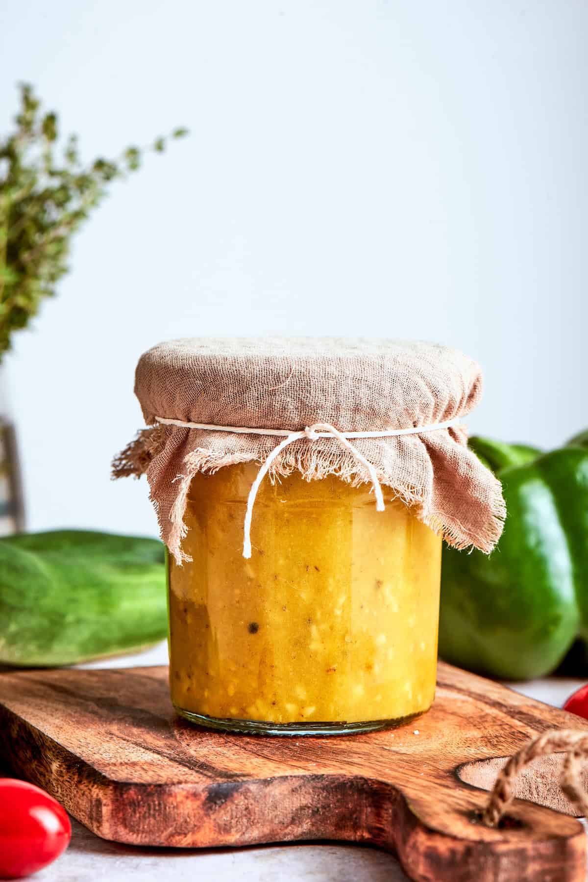 Bright and tangy, with lots of garlic and oregano, this Greek Salad Dressing is easy to make and tastes SO much better than store-bought! Jar of Greek salad dressing with burlap tied around lid