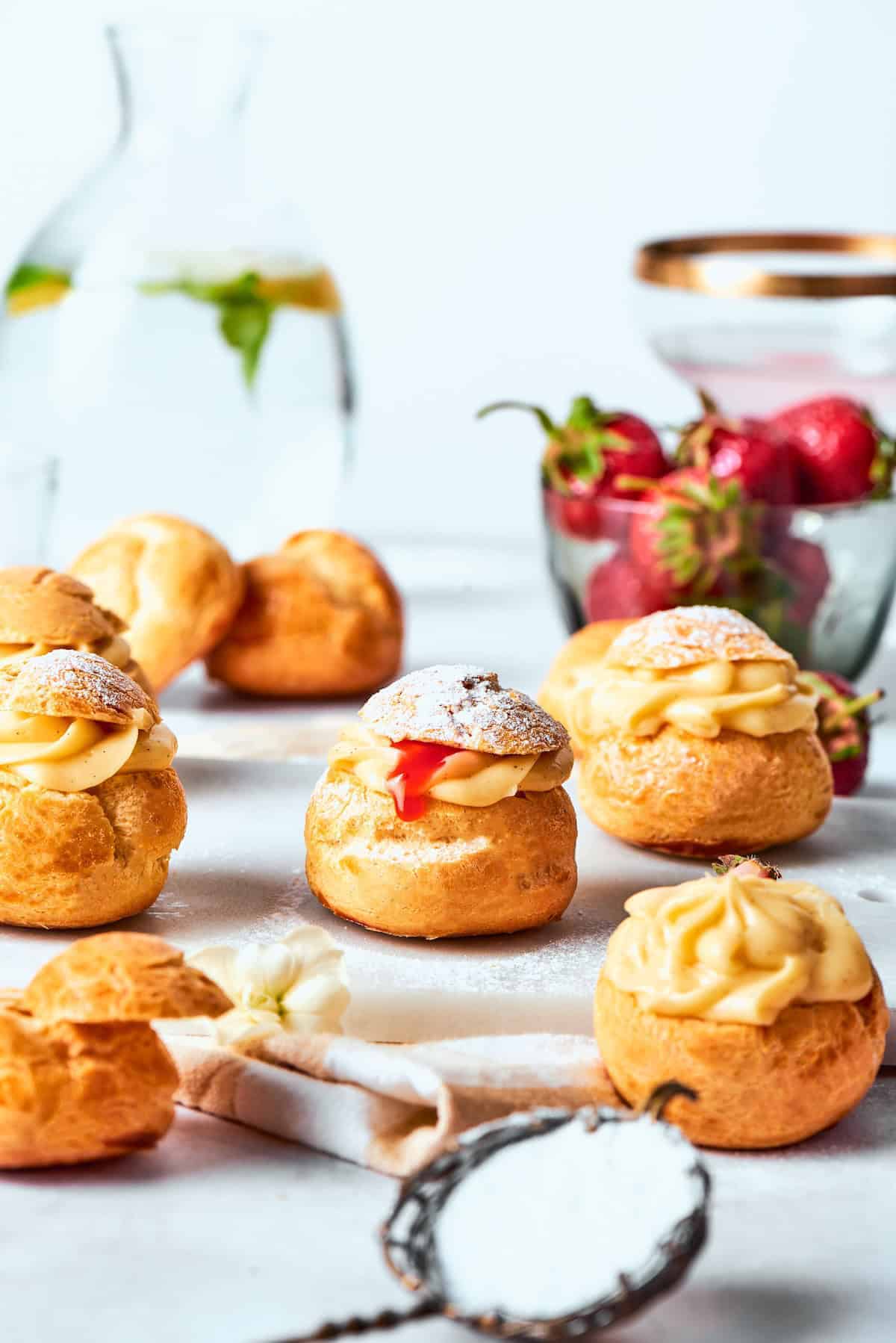 mini cream puffs filled with vanilla pastry cream and fresh strawberry sauce