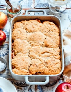 a white rectangular baking dish with baked Apple Cobbler