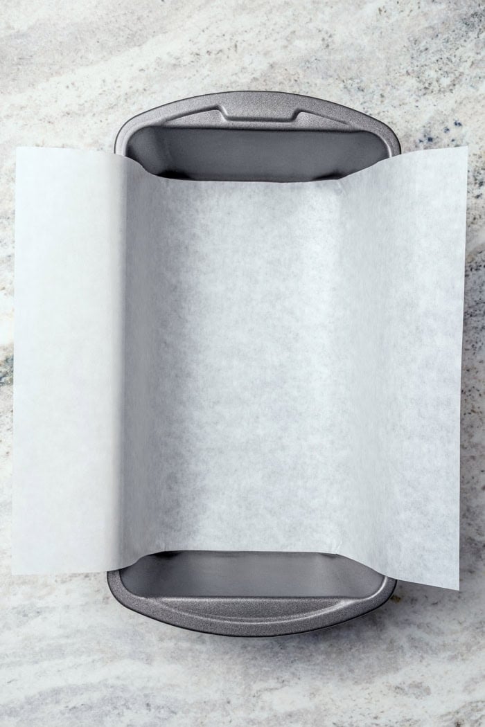 Sling of parchment paper in loaf pan.