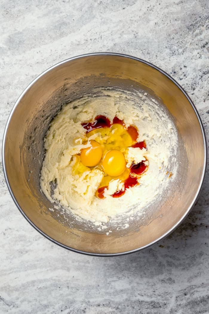Eggs and vanilla added to creamed butter and sugar.