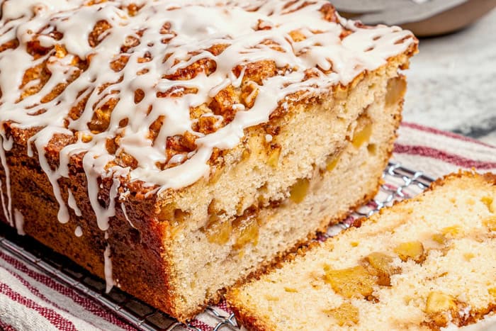 glazed apple fritter bread, sliced to show the fresh apple filling inside