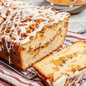glazed apple fritter bread, sliced to show the fresh apple filling inside