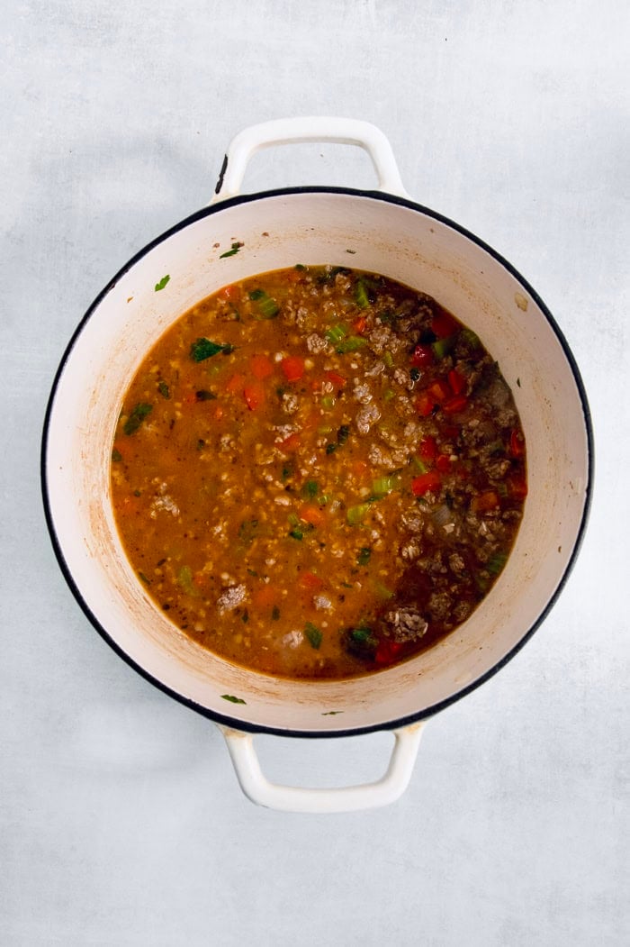 Dirty rice simmering in Dutch oven.