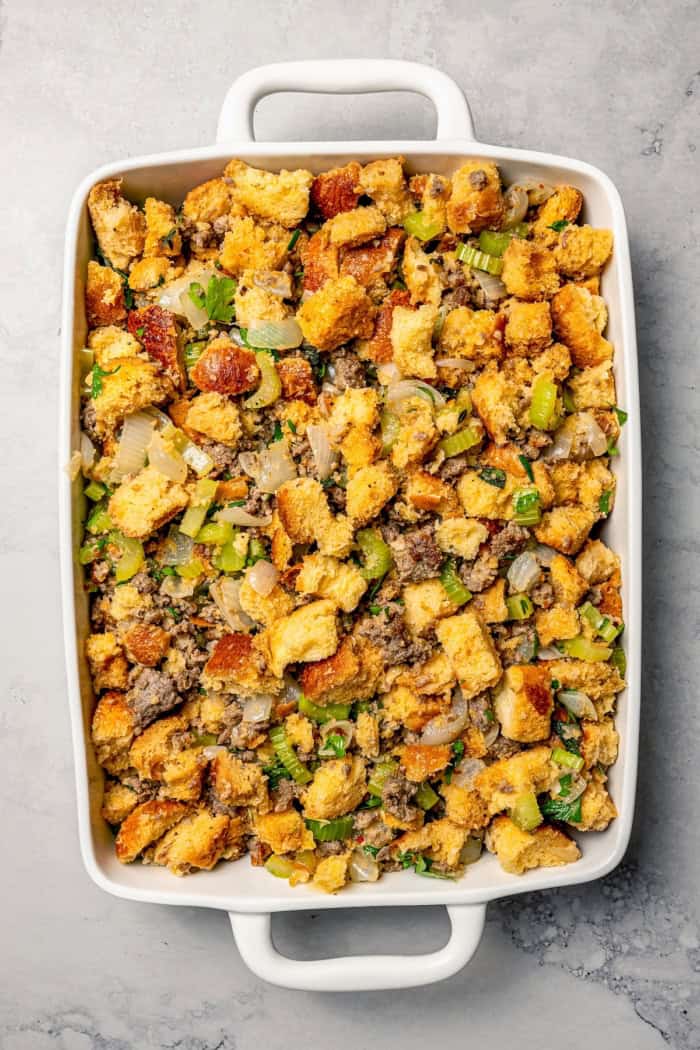 Unbaked sausage stuffing in baking dish.