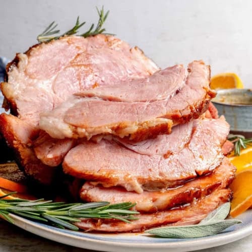 cooked ham on a platter, sliced