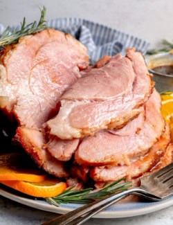 Sliced ham with orange-brown sugar ham glaze.