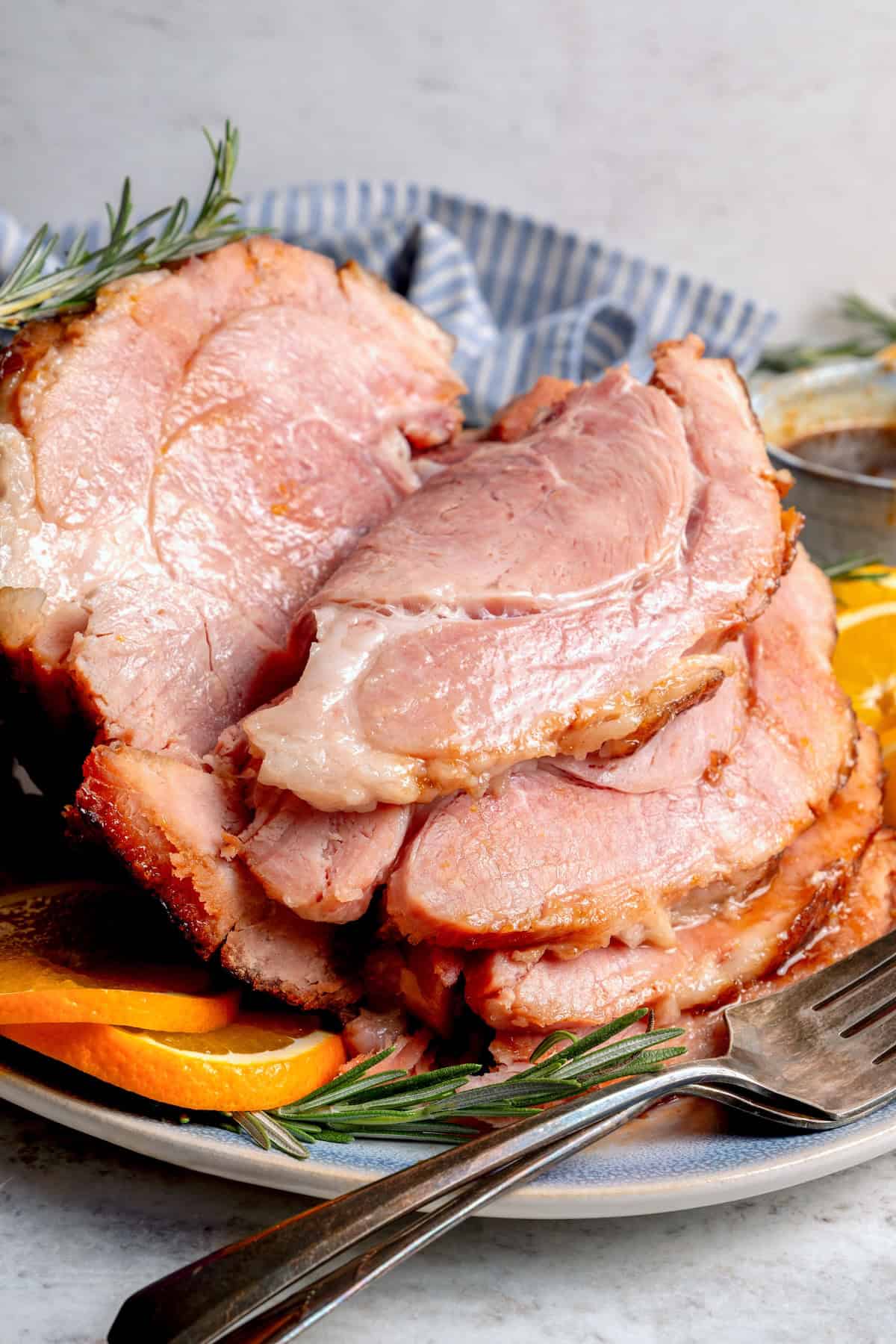 Sliced ham with orange-brown sugar ham glaze.