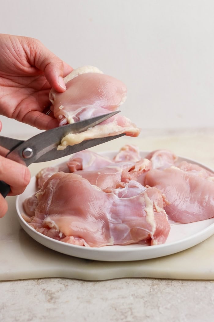 These Grilled Chicken Thighs are tender and juicy, with a smoky char that plays perfectly with the sweet-and-savory seasoning blend. So easy! Trimming boneless skinless chicken thighs.
